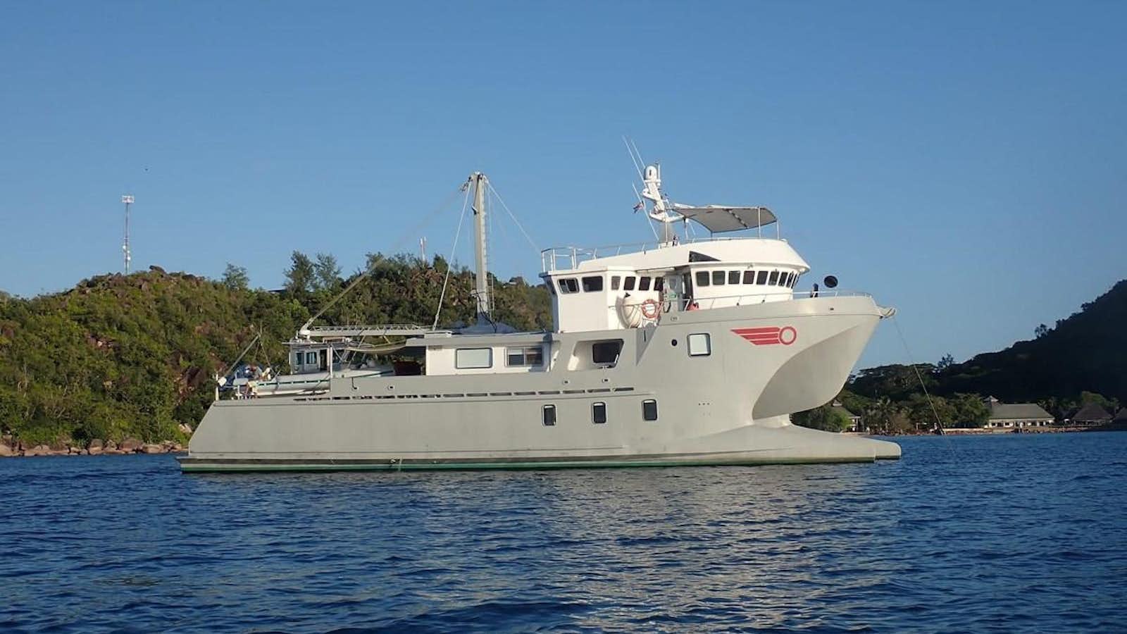 a white boat in the water aboard ROGUE Yacht for Sale