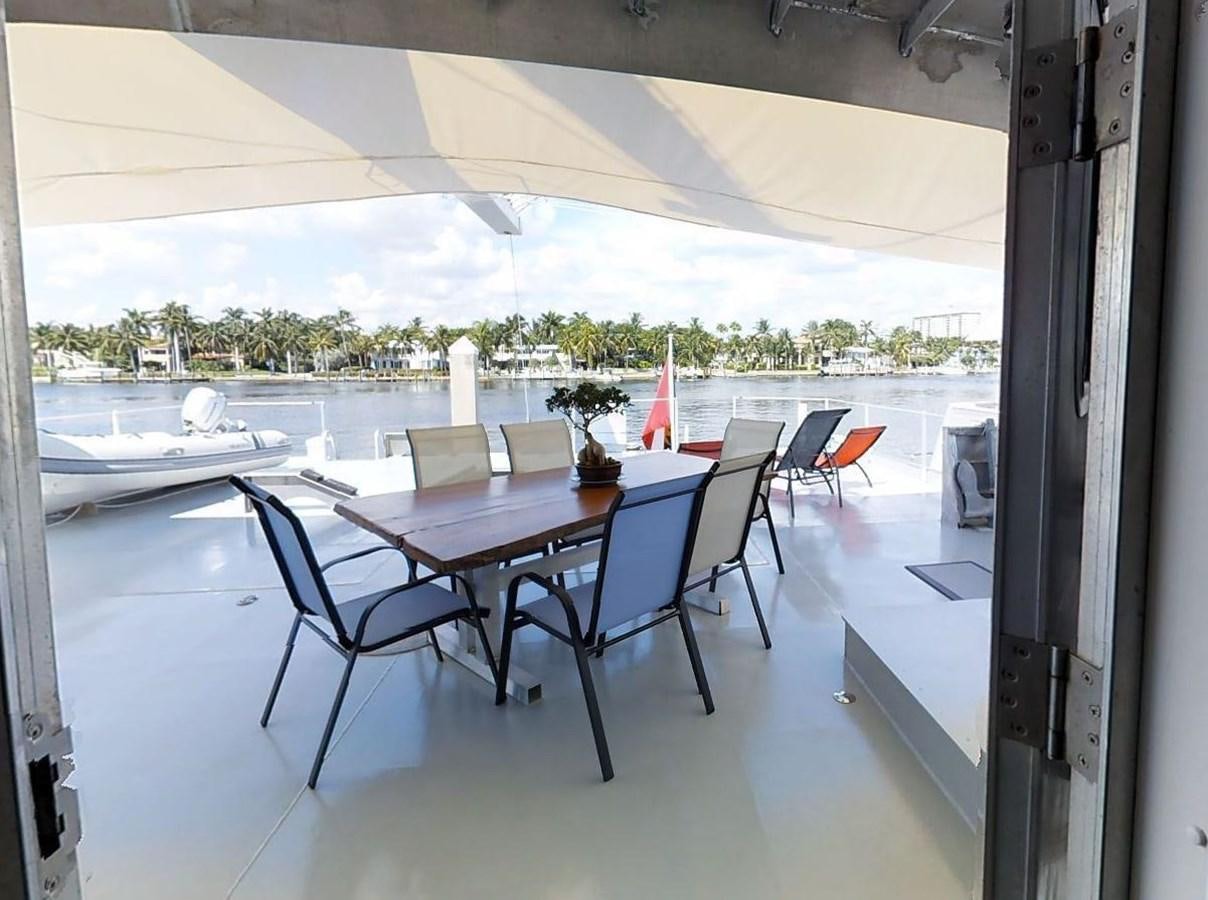 a table and chairs on a deck aboard BASILISK Yacht for Sale