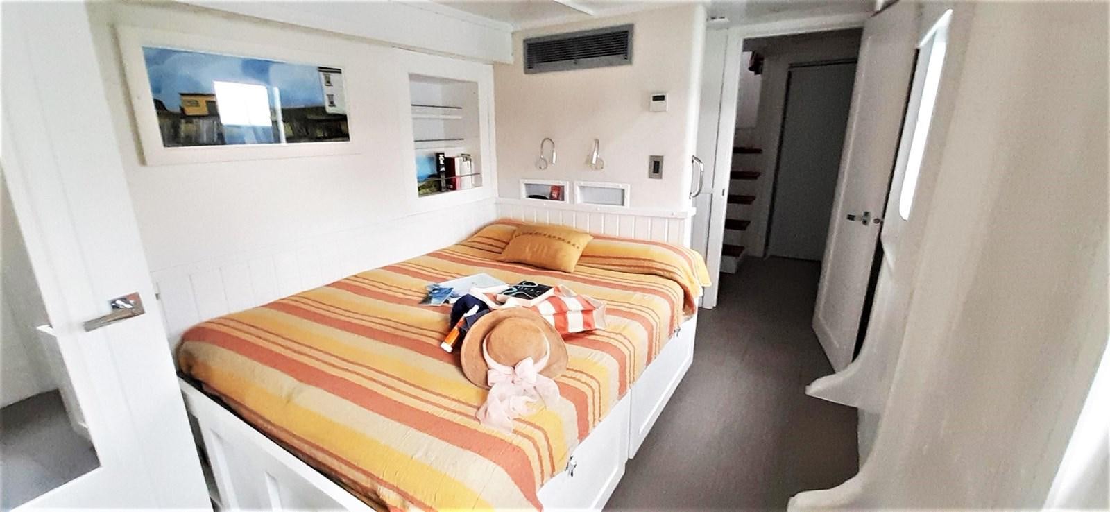 a bedroom with a bed and a dog aboard BASILISK Yacht for Sale