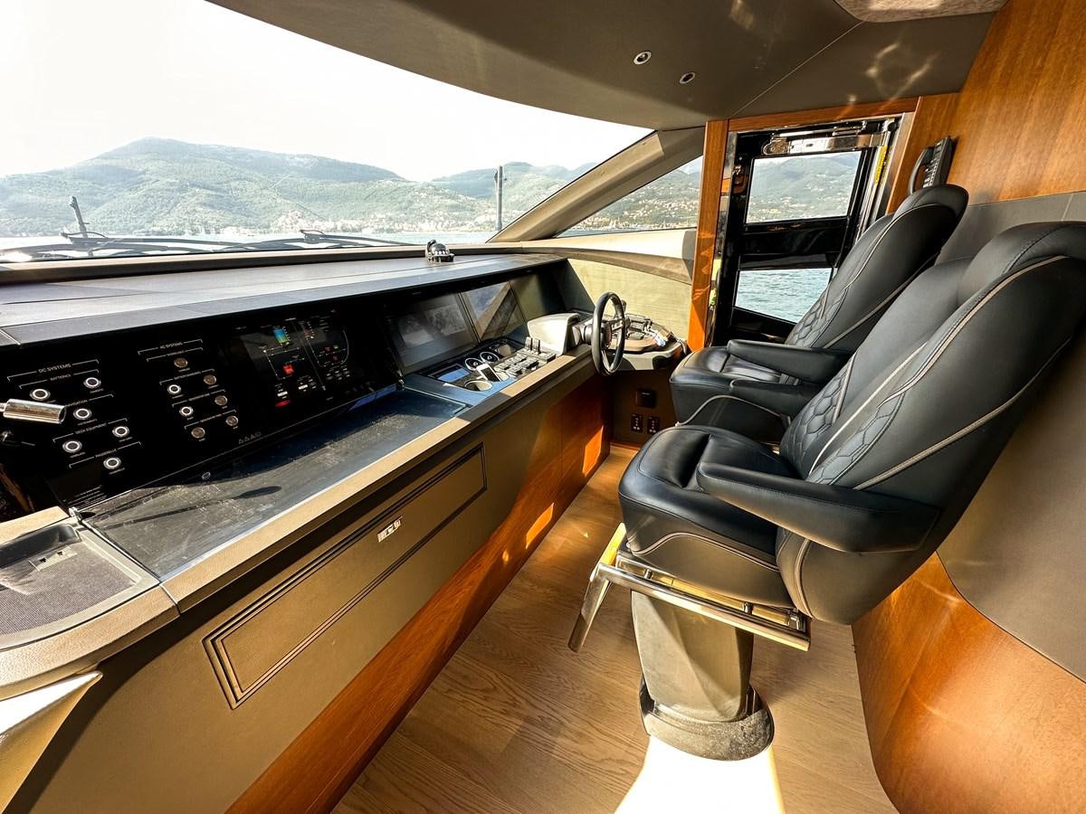 a car with a seat and a desk in the back aboard AHAVA Yacht for Sale