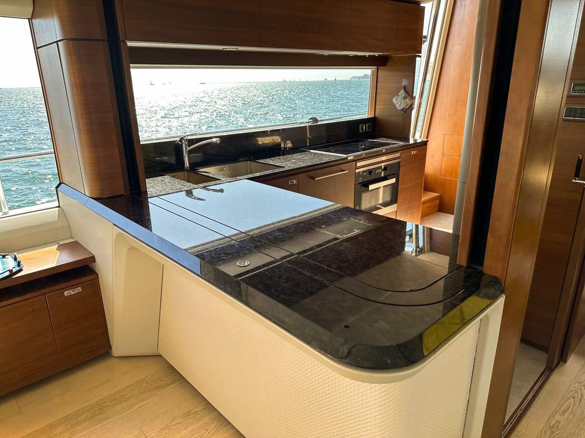 a kitchen with a large window aboard AHAVA Yacht for Sale
