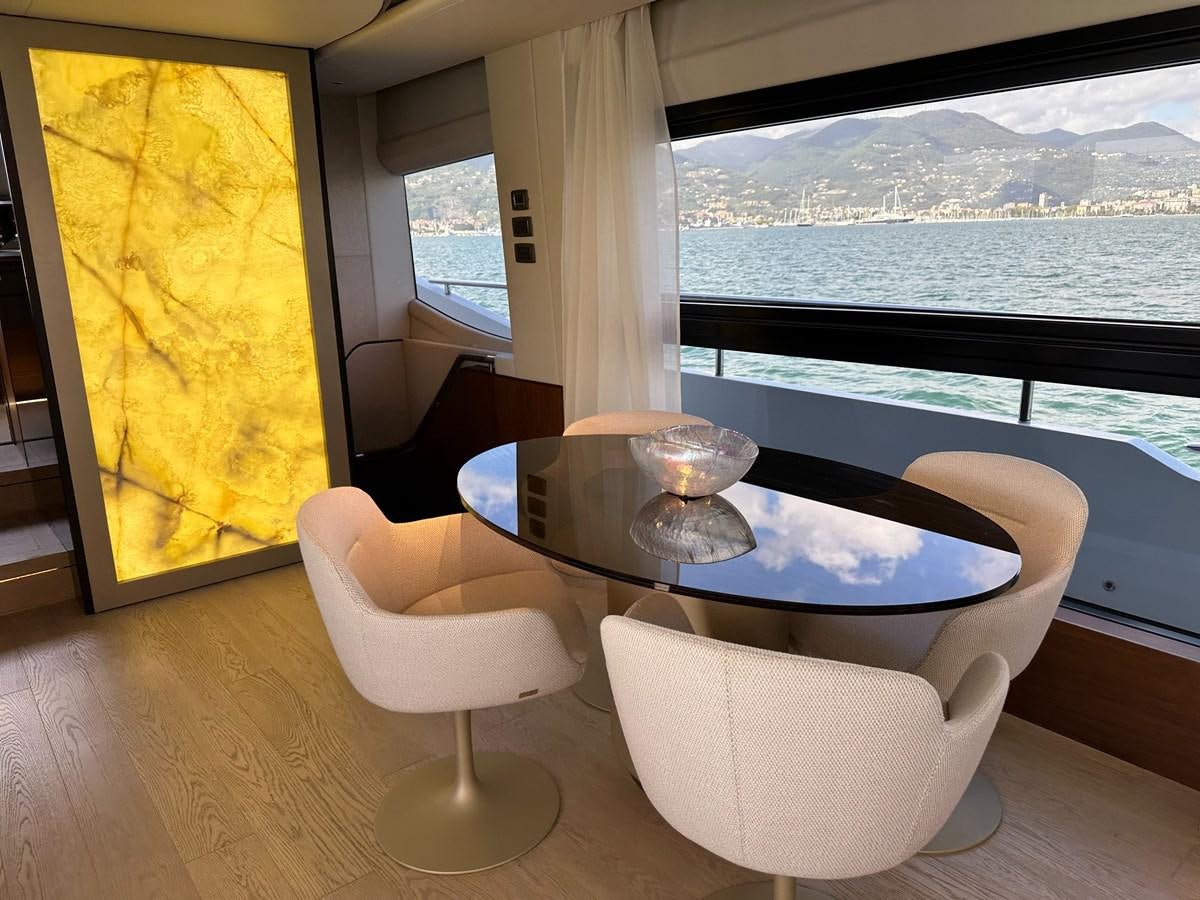 a table with chairs on it aboard AHAVA Yacht for Sale