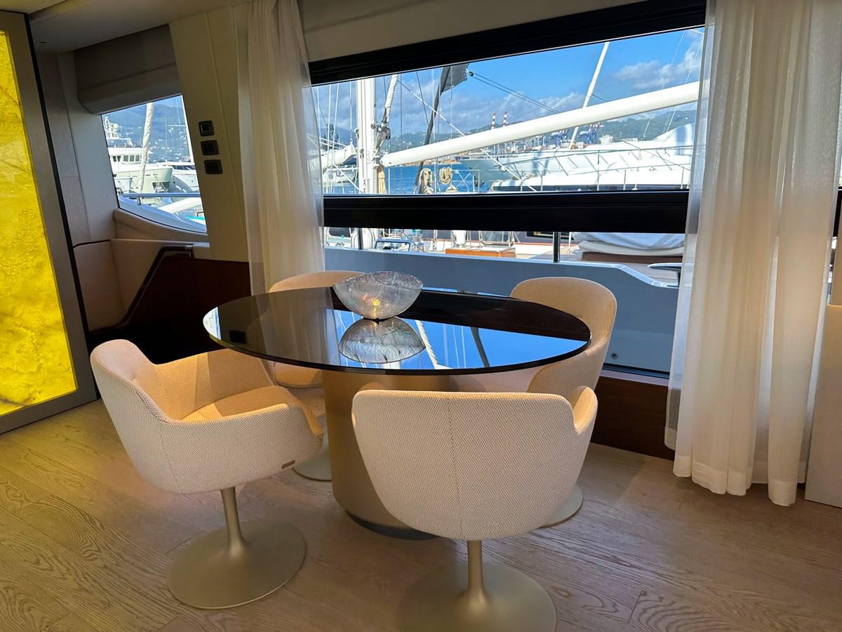 a table with chairs on it aboard AHAVA Yacht for Sale