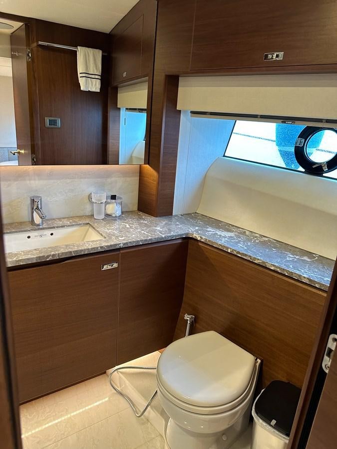 a bathroom with a toilet and a sink aboard AHAVA Yacht for Sale
