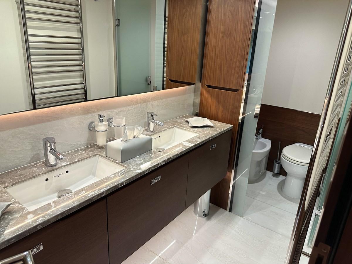 a bathroom with a countertop sink and a mirror aboard AHAVA Yacht for Sale