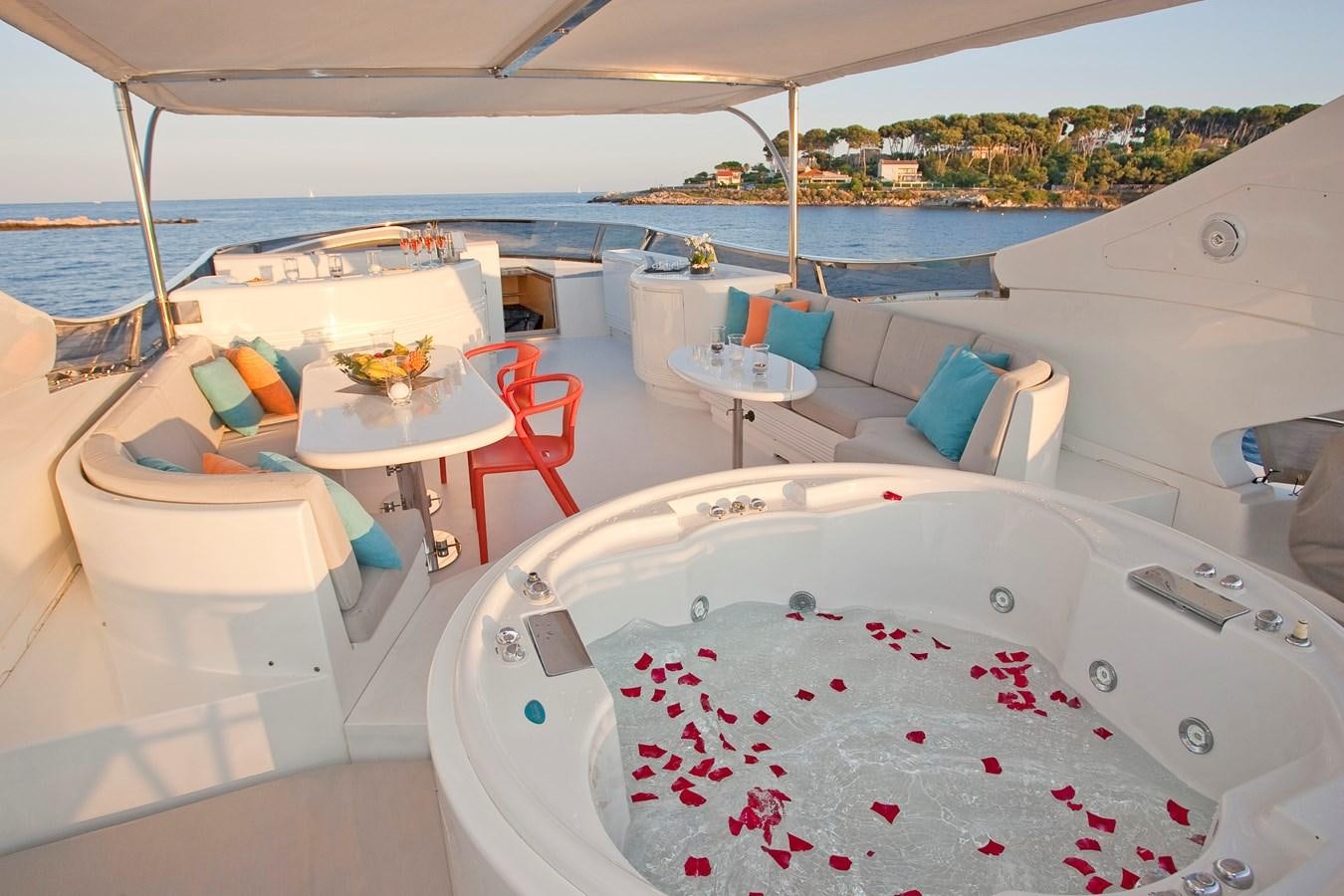 a room with a table and chairs aboard COCA VI Yacht for Sale