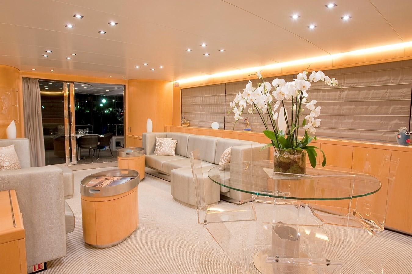 a large room with a table and chairs aboard COCA VI Yacht for Sale