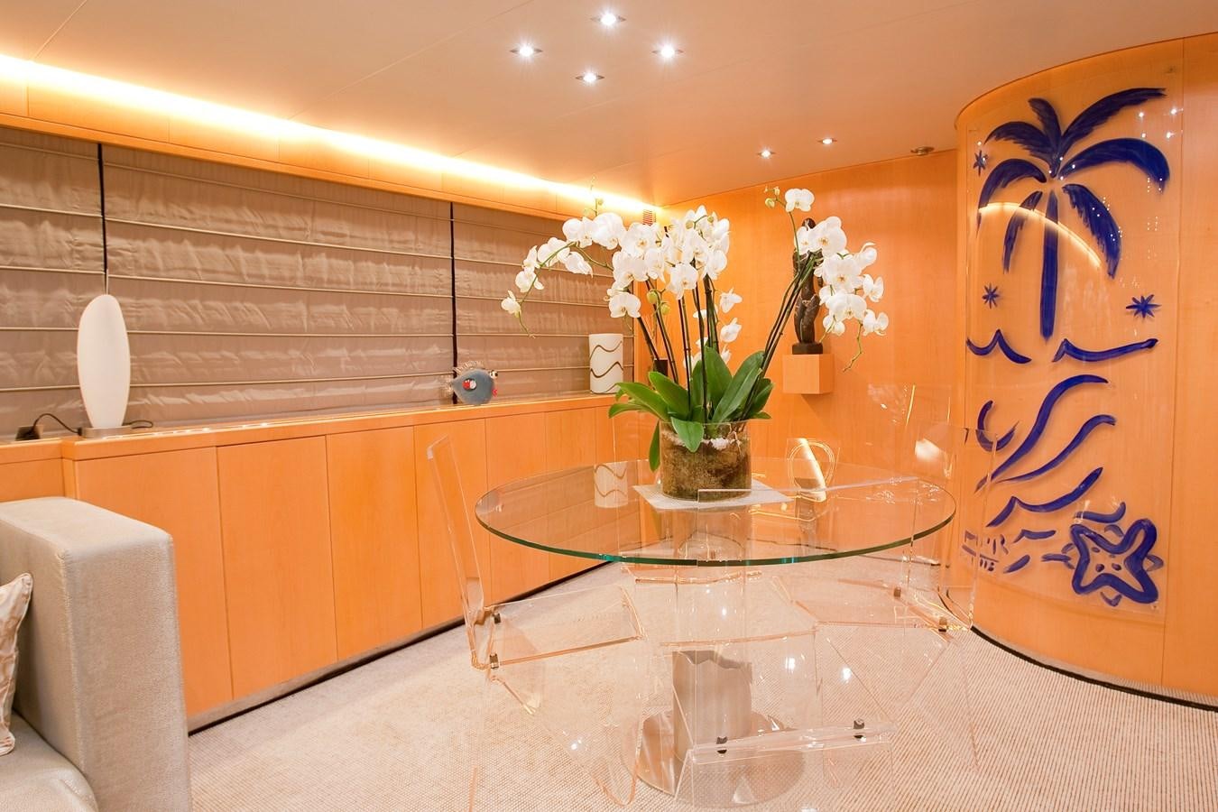 a table with white flowers on it aboard COCA VI Yacht for Sale