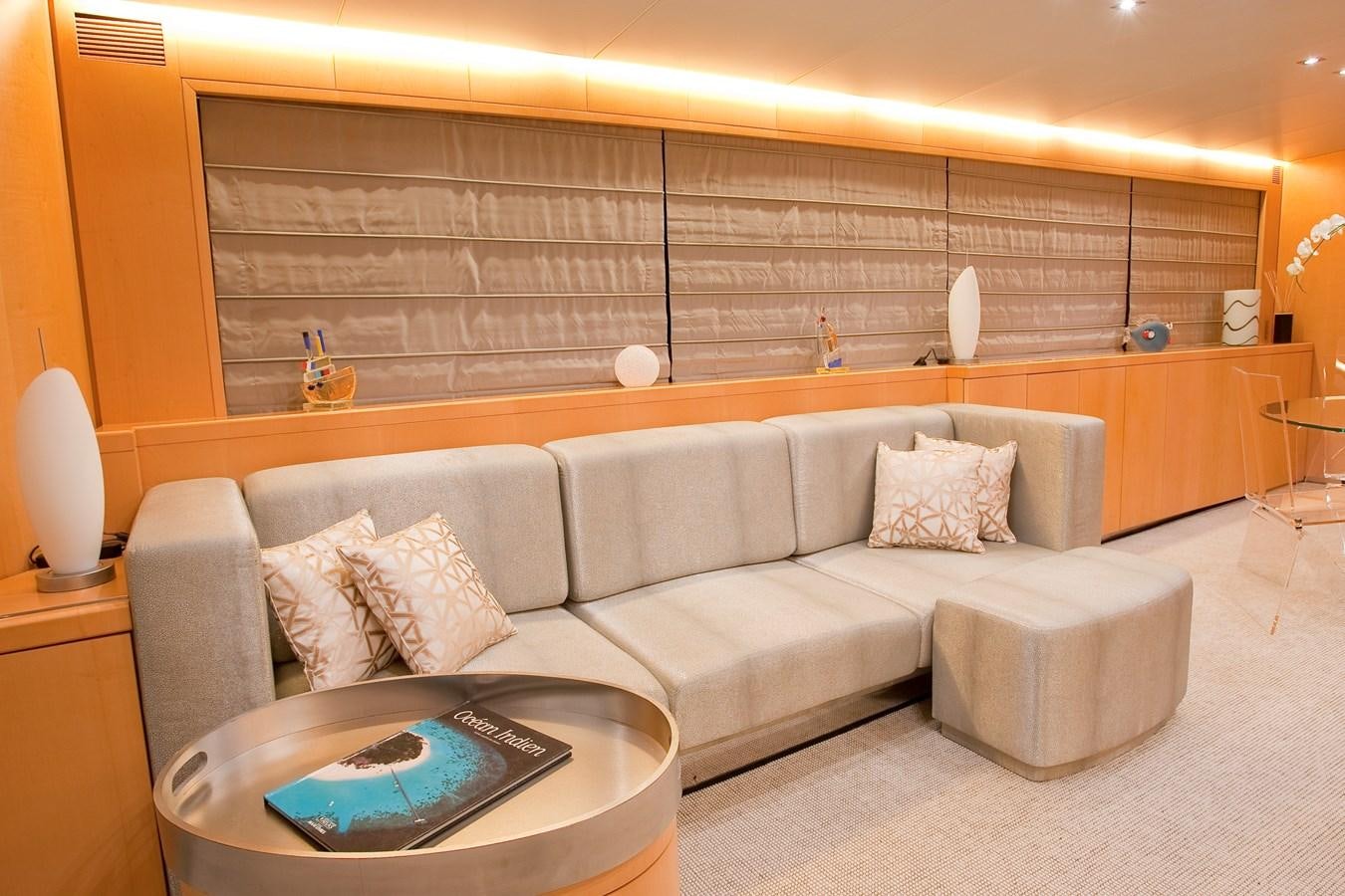 a couch in a room aboard COCA VI Yacht for Sale