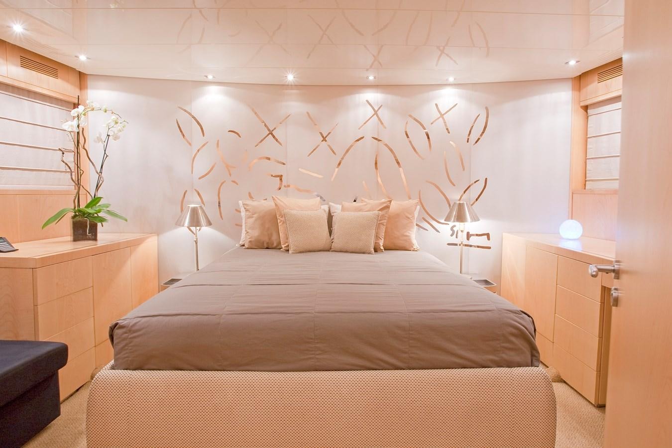 a bed with a flowered wall aboard COCA VI Yacht for Sale