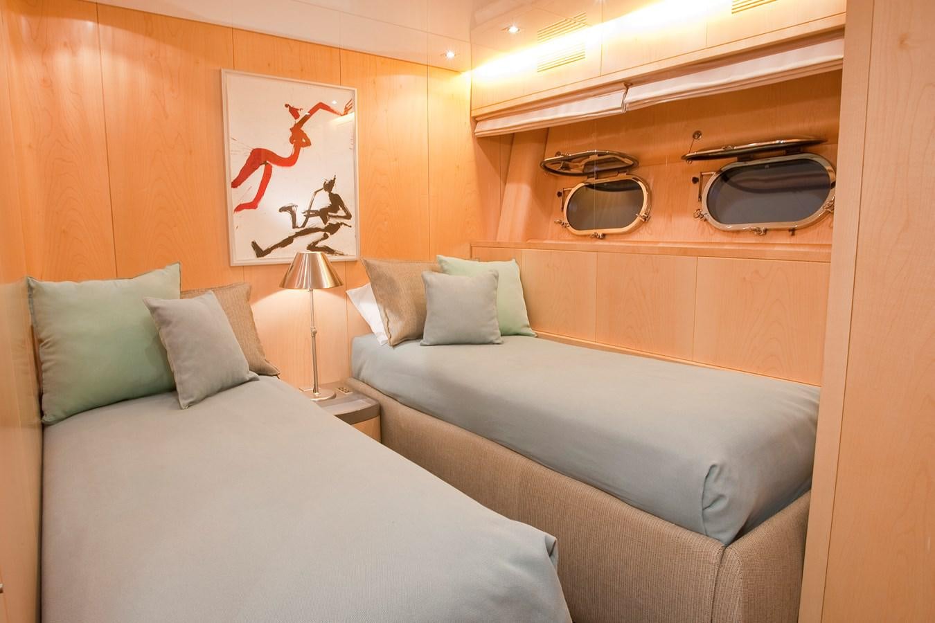a bedroom with a bed and a television aboard COCA VI Yacht for Sale