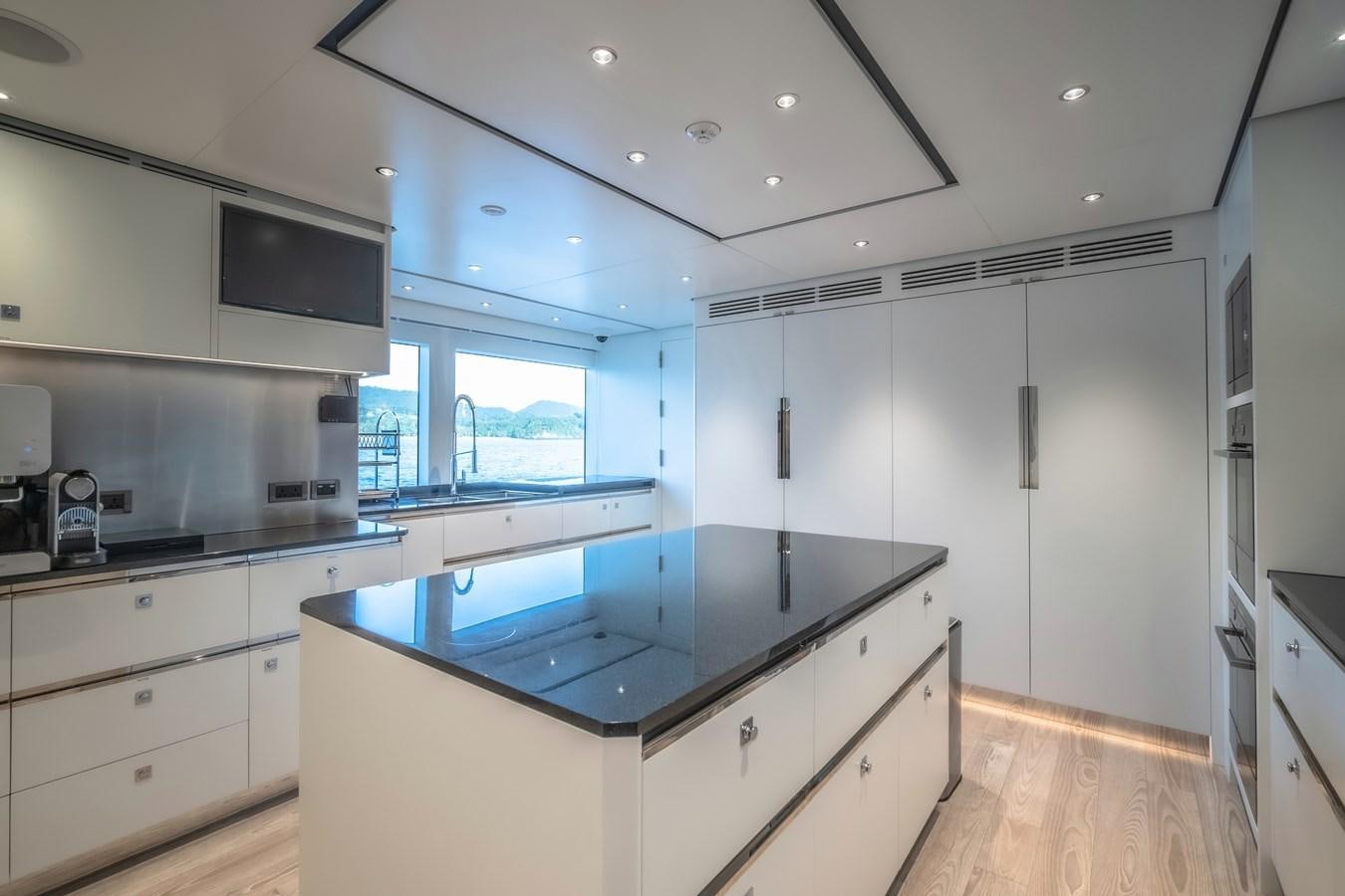 a kitchen with white cabinets aboard SONG OF SONGS Yacht for Sale