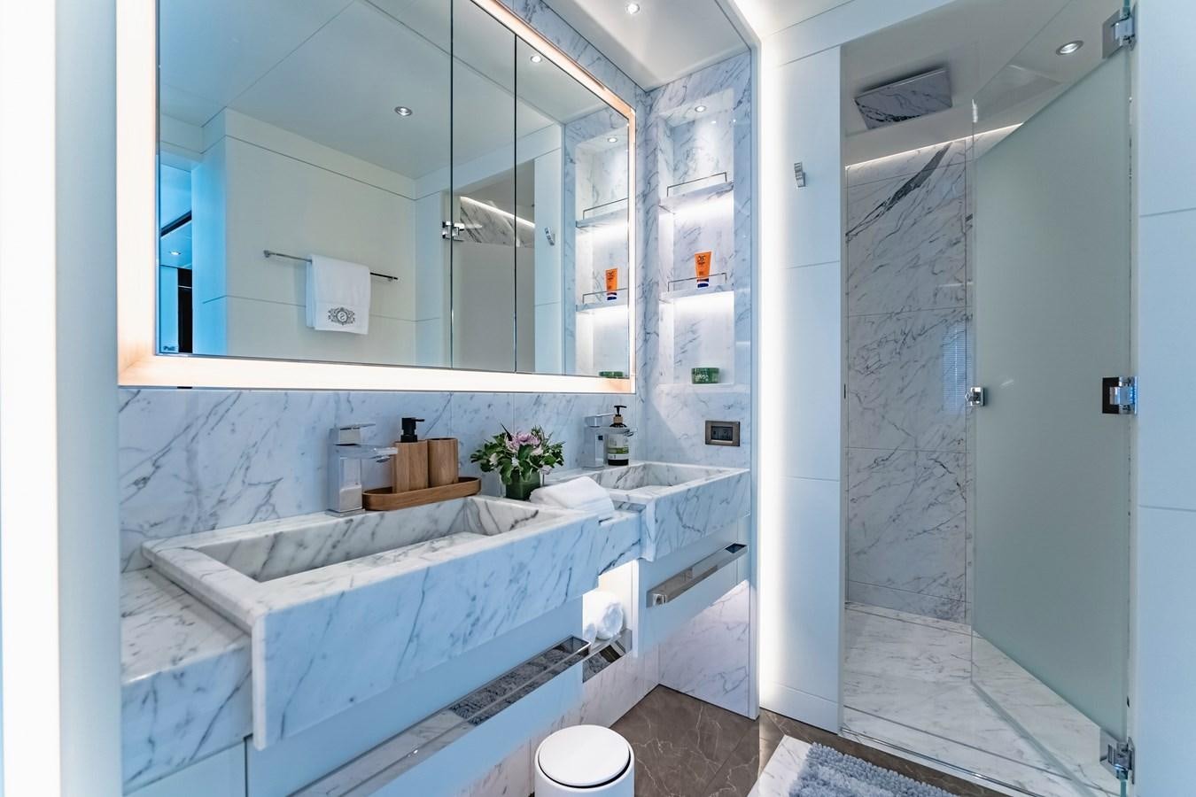 a bathroom with a tub sink and a mirror aboard SONG OF SONGS Yacht for Sale