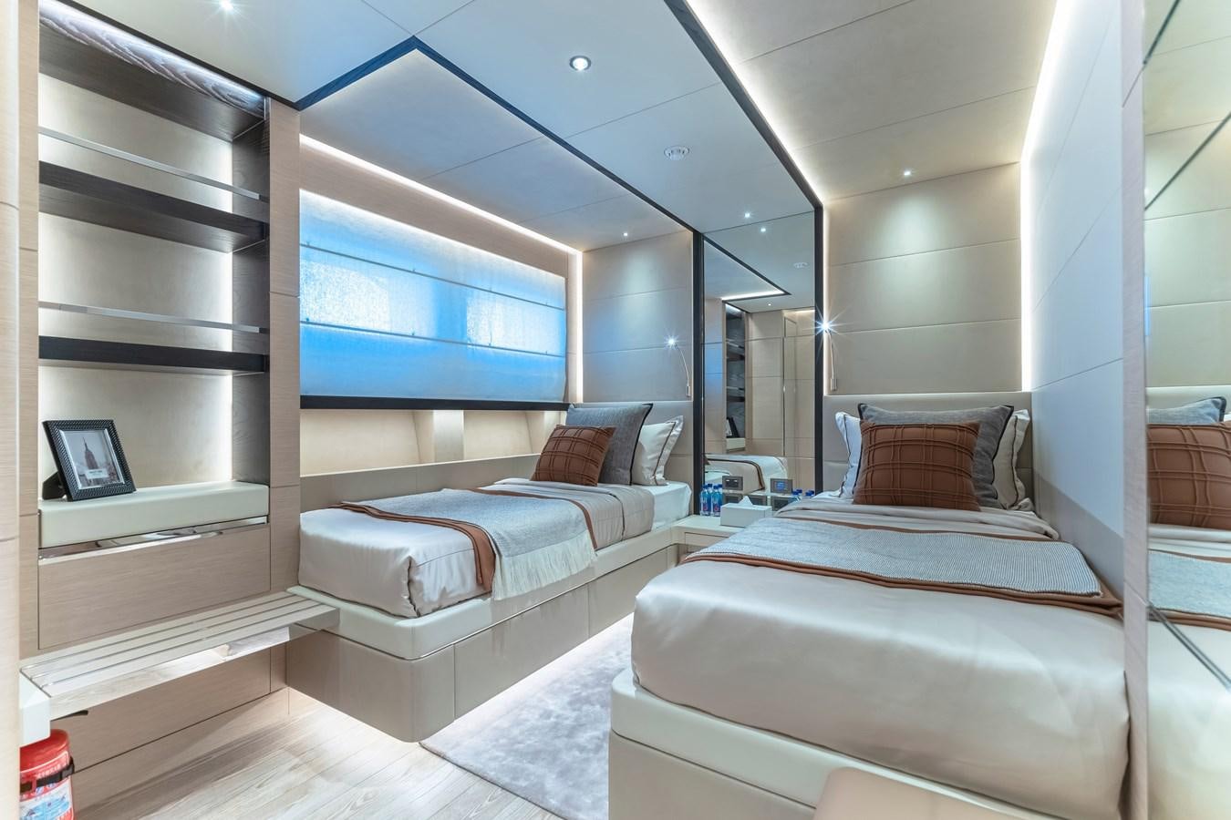 a room with a bed and a mirror aboard SONG OF SONGS Yacht for Sale