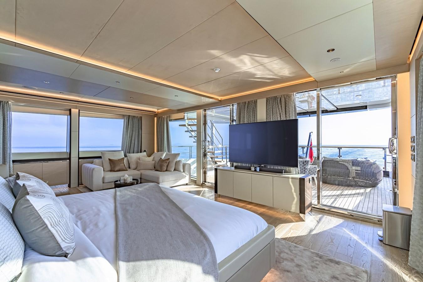a bedroom with a large bed and a flat screen tv aboard SONG OF SONGS Yacht for Sale