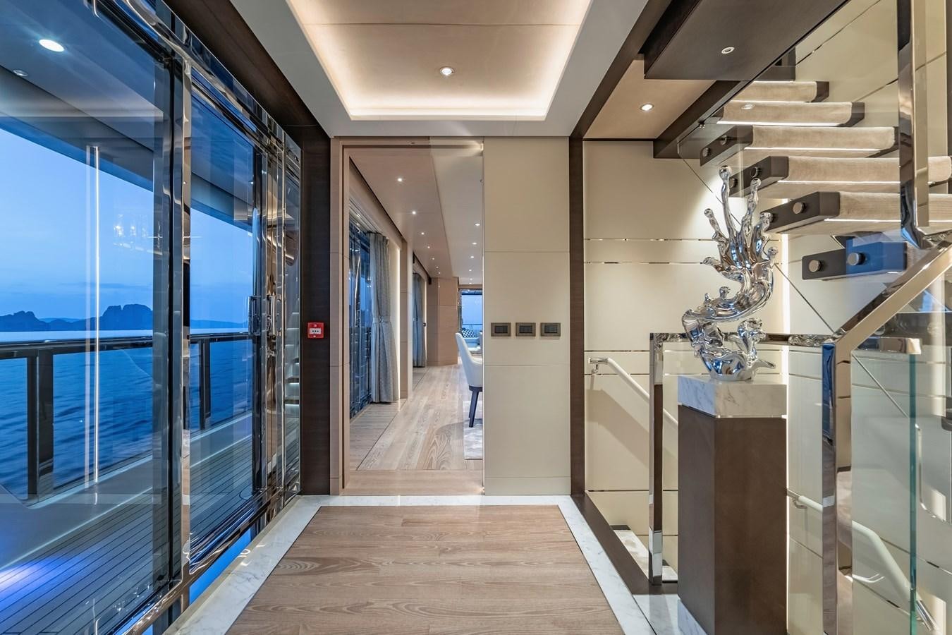 a hallway with glass doors aboard SONG OF SONGS Yacht for Sale