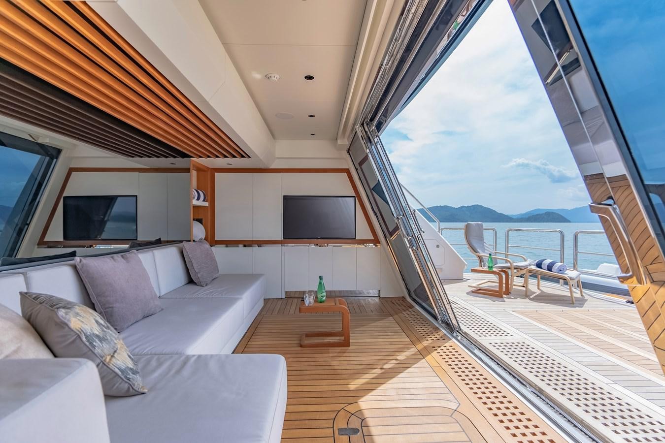 a living room with a large balcony aboard SONG OF SONGS Yacht for Sale