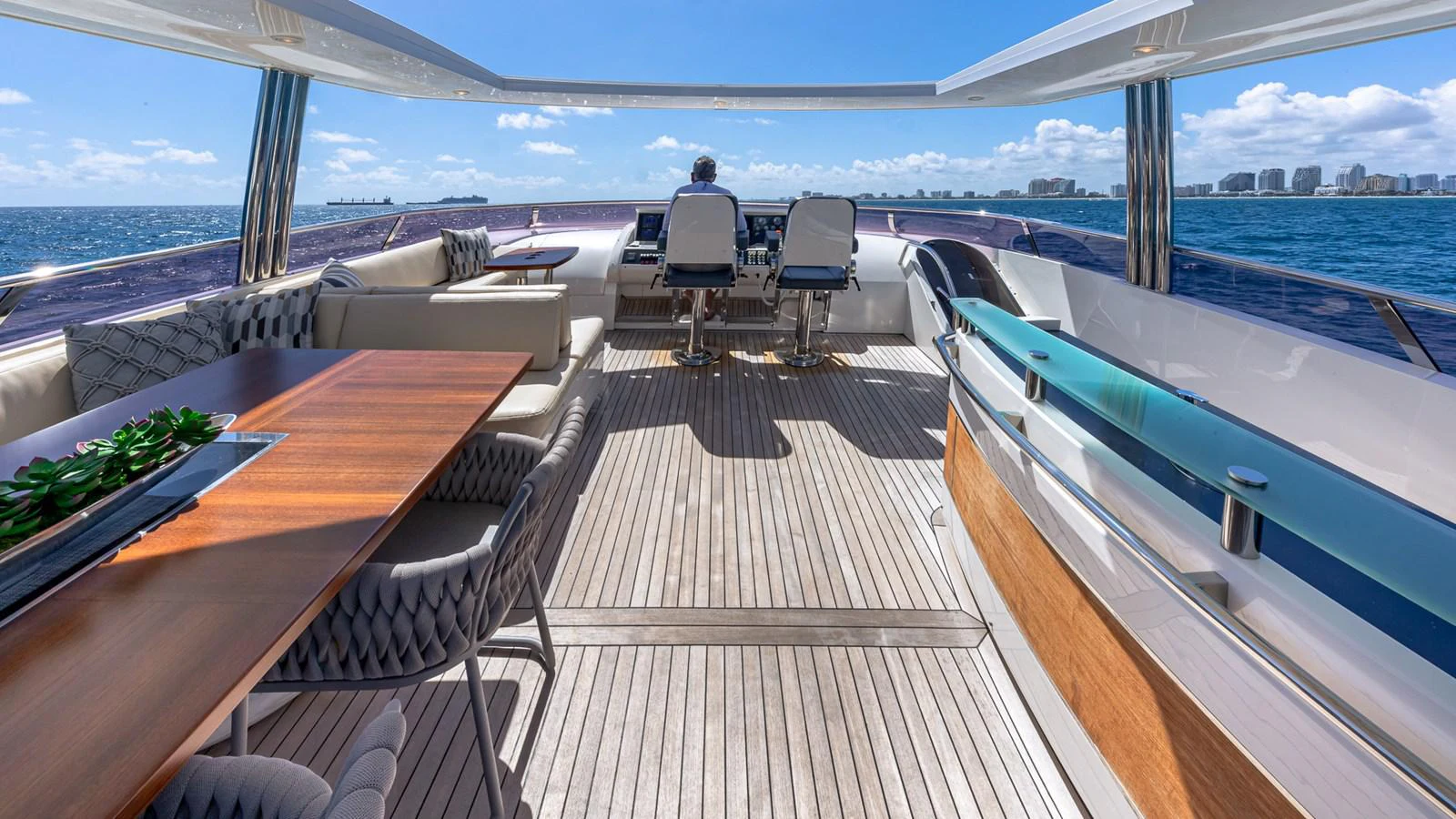 a deck with a table and chairs on it aboard LADY COPE Yacht for Sale