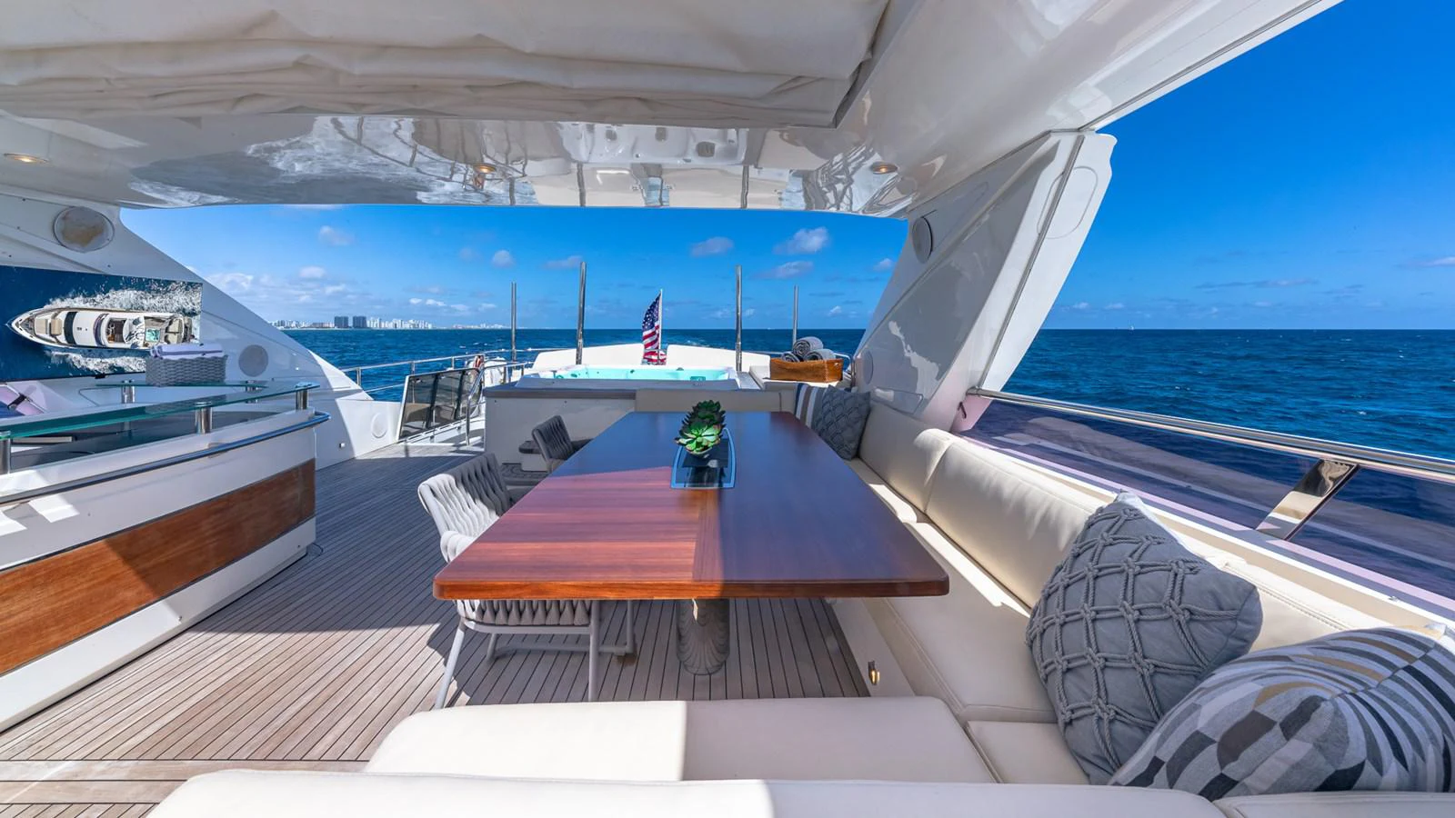 a deck with a table and chairs on it aboard LADY COPE Yacht for Sale