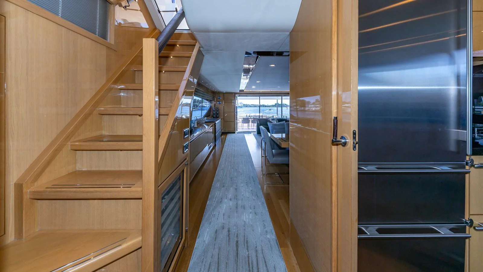 a room with wooden floors and a large glass door aboard LADY COPE Yacht for Sale