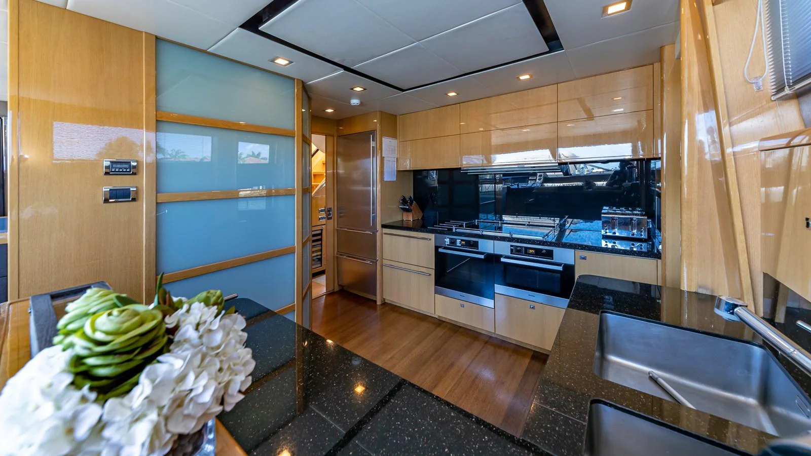 a kitchen with a countertop sink and cabinets aboard LADY COPE Yacht for Sale