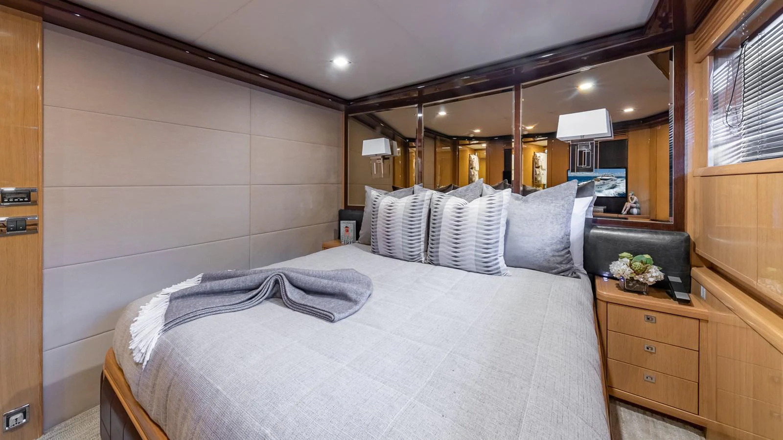 a bedroom with a bed and a dresser aboard LADY COPE Yacht for Sale