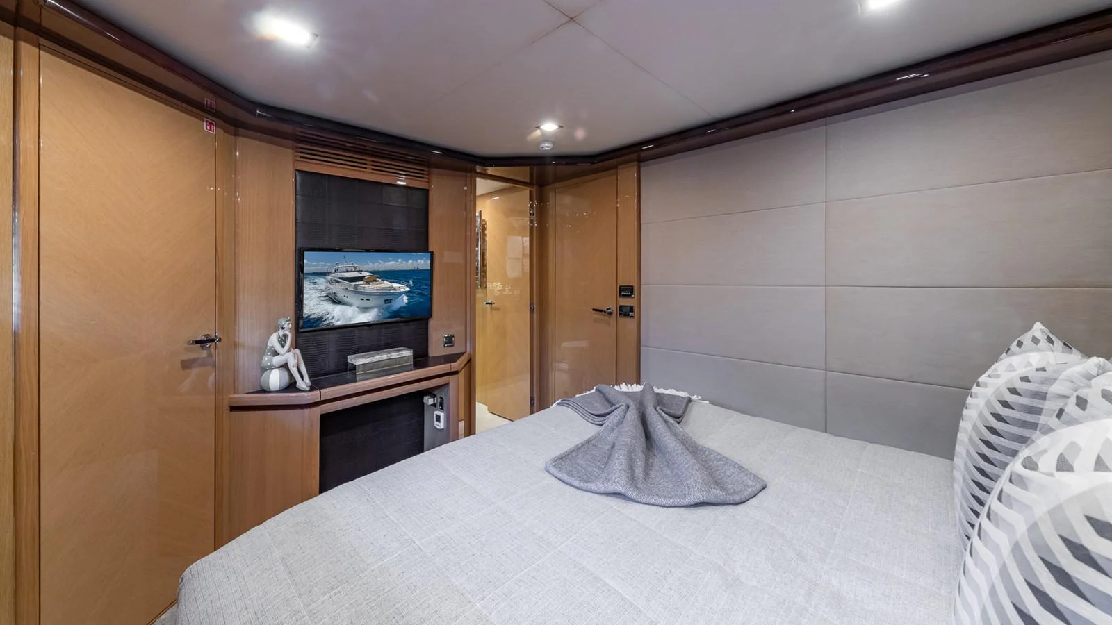 a bedroom with a bed and a television aboard LADY COPE Yacht for Sale