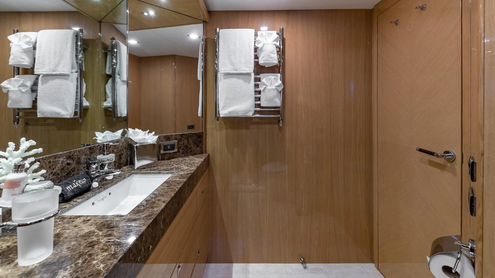 a bathroom with a countertop sink and towels aboard LADY COPE Yacht for Sale