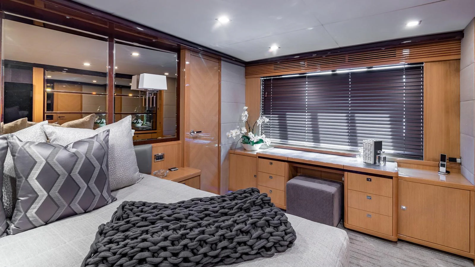 a bedroom with a bed and desk aboard LADY COPE Yacht for Sale