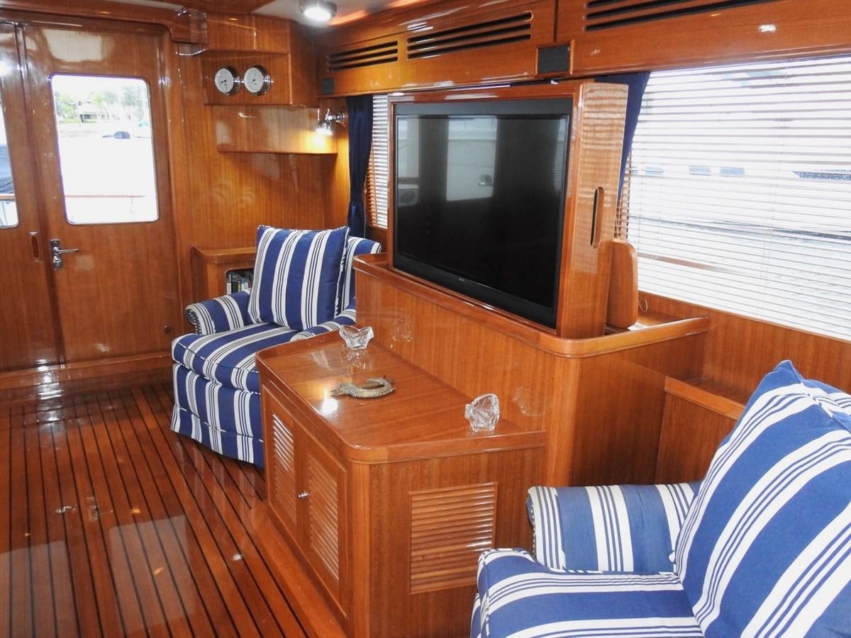 a living room with a wood paneled wall aboard TELEMETRY Yacht for Sale