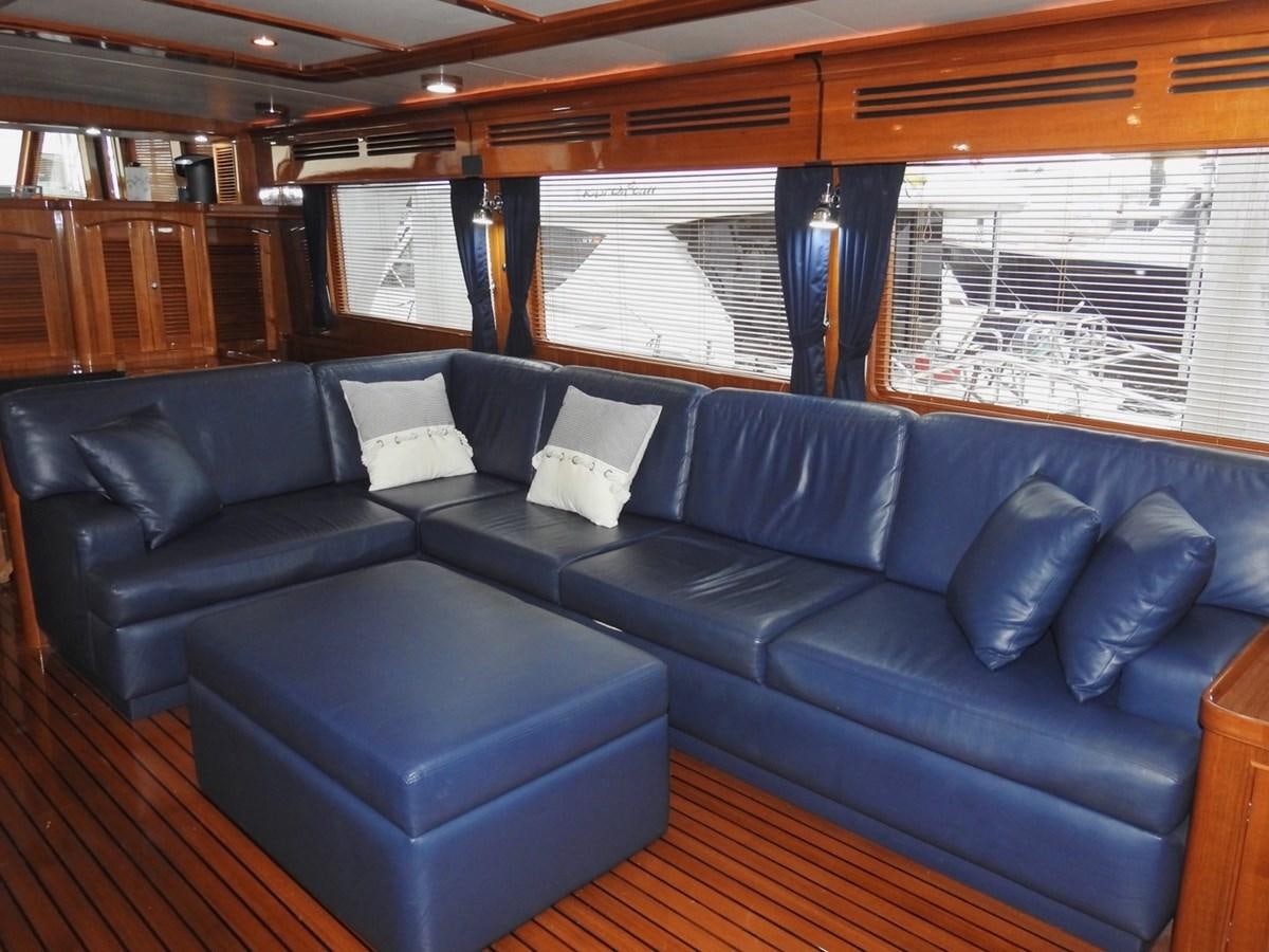 a blue couch in a room aboard TELEMETRY Yacht for Sale
