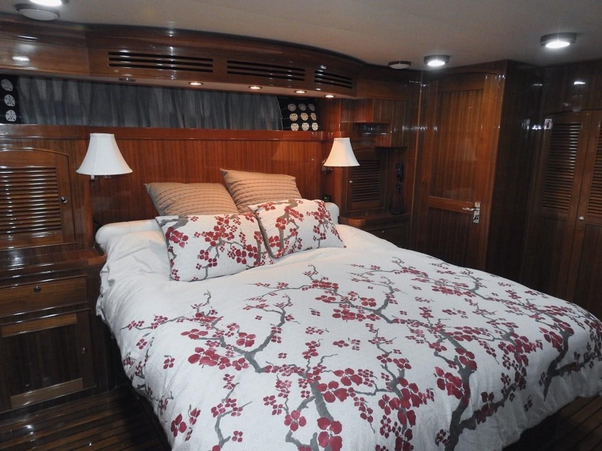 a bed with a white comforter aboard TELEMETRY Yacht for Sale