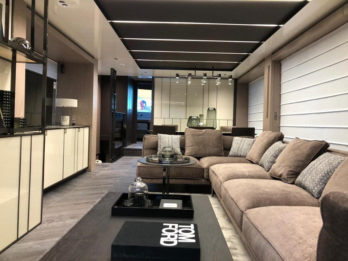 a living room with a couch and a coffee table aboard SETTANTOTTO 78 Yacht for Sale