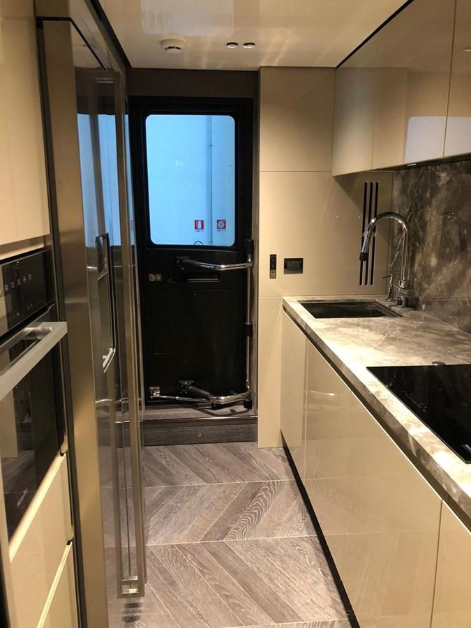 a kitchen with a glass door aboard SETTANTOTTO 78 Yacht for Sale