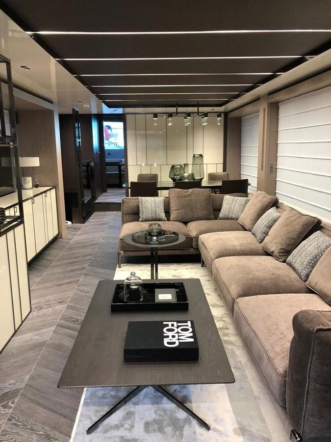 a living room with a couch and a coffee table aboard SETTANTOTTO 78 Yacht for Sale