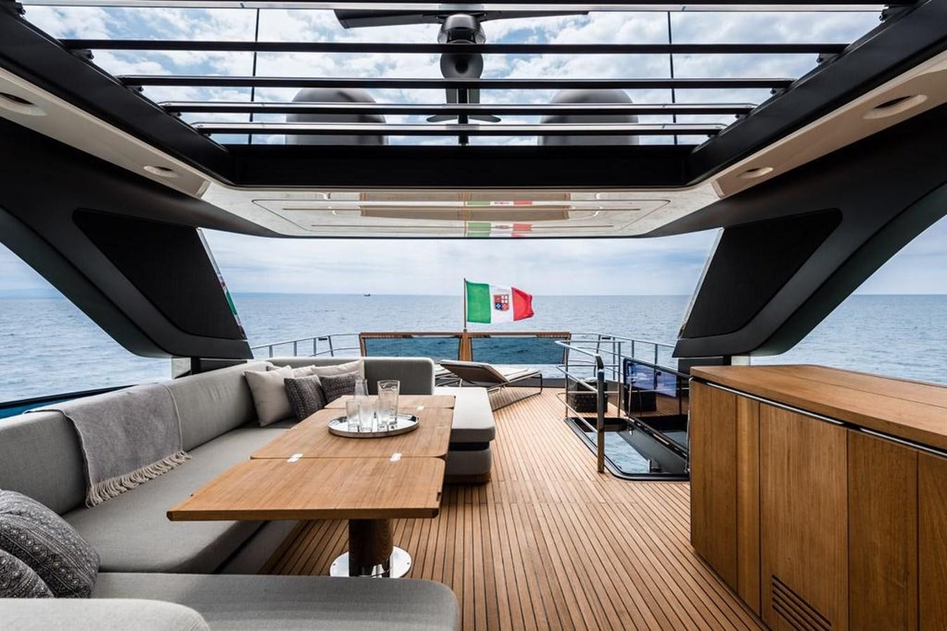 a room with a couch and a table and a view of the ocean aboard SETTANTOTTO 78 Yacht for Sale