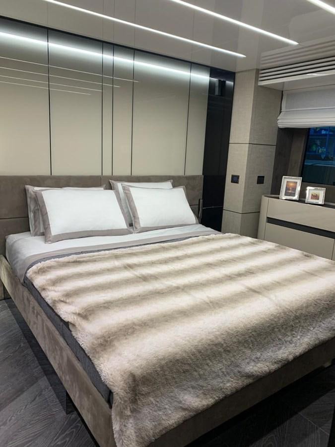 a bed with a white comforter aboard SETTANTOTTO 78 Yacht for Sale