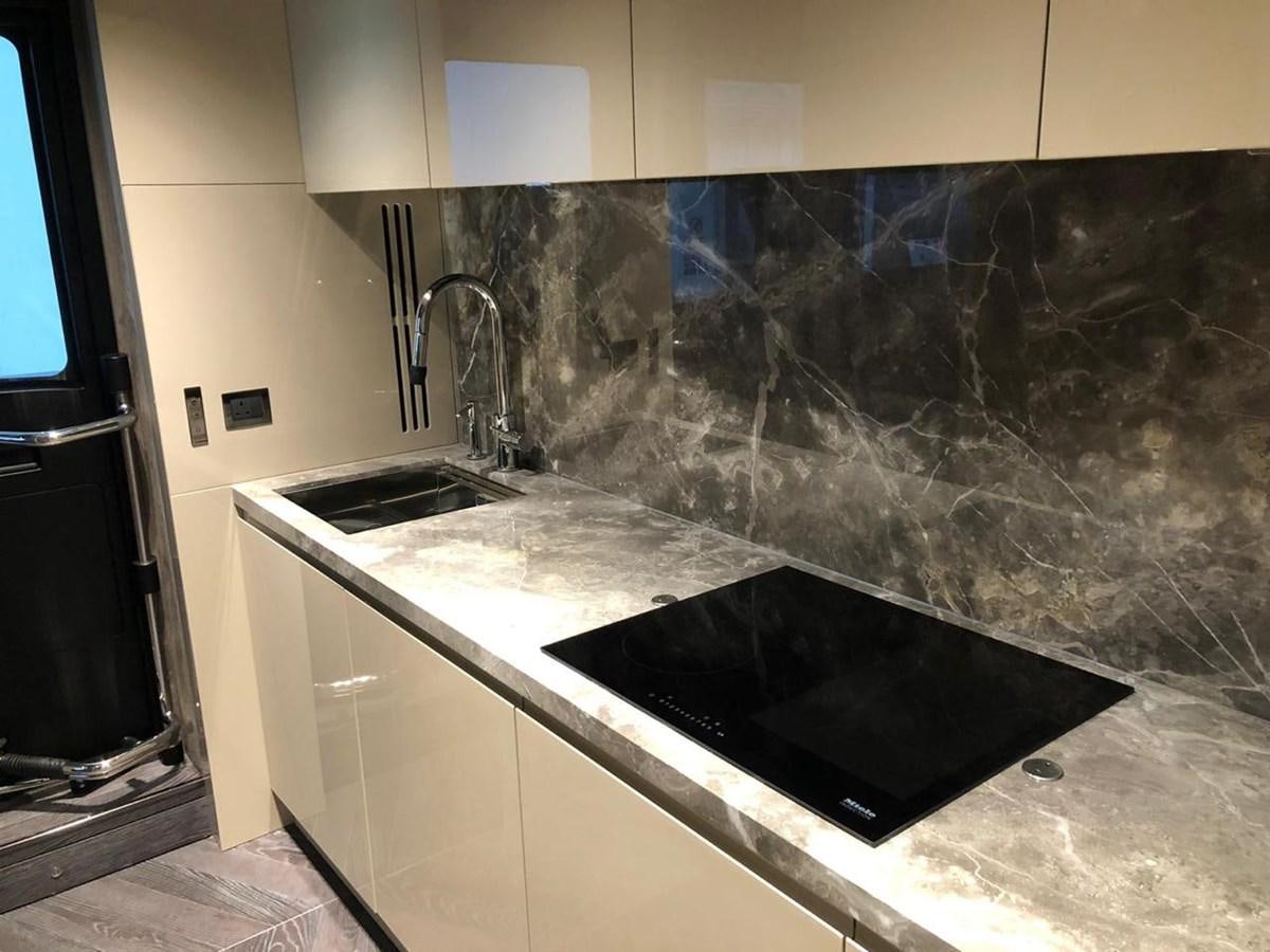 a kitchen with a black counter top aboard SETTANTOTTO 78 Yacht for Sale