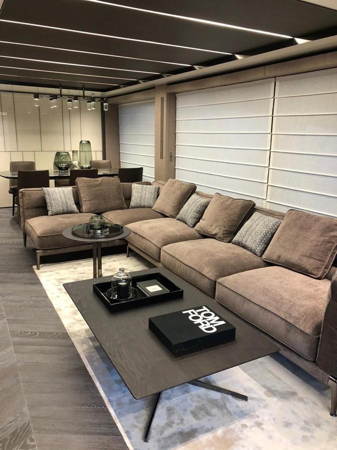 a living room with a couch and coffee table aboard SETTANTOTTO 78 Yacht for Sale