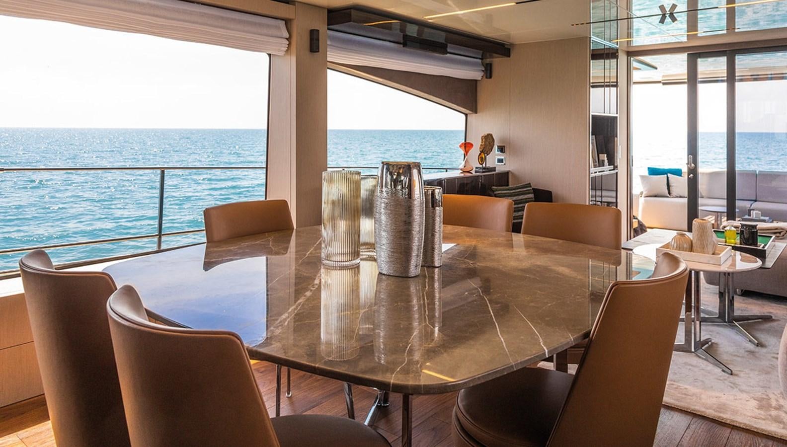 a room with a table and chairs aboard SESSANTASETTE 67 Yacht for Sale