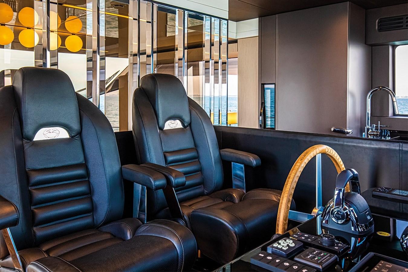 a room with chairs and a laptop aboard SESSANTASETTE 67 Yacht for Sale