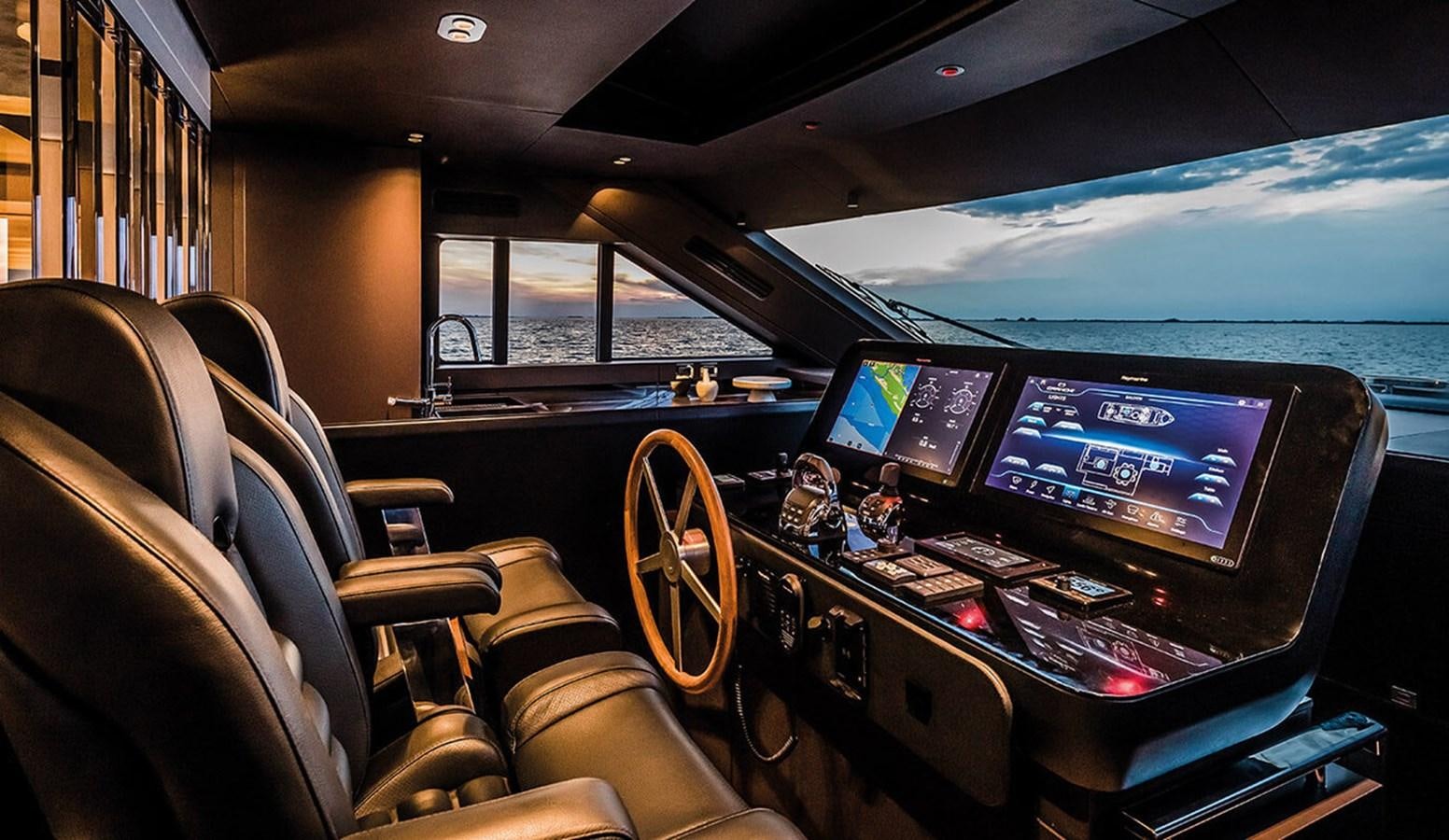 inside of a car with a screen and a computer on the dashboard aboard SESSANTASETTE 67 Yacht for Sale