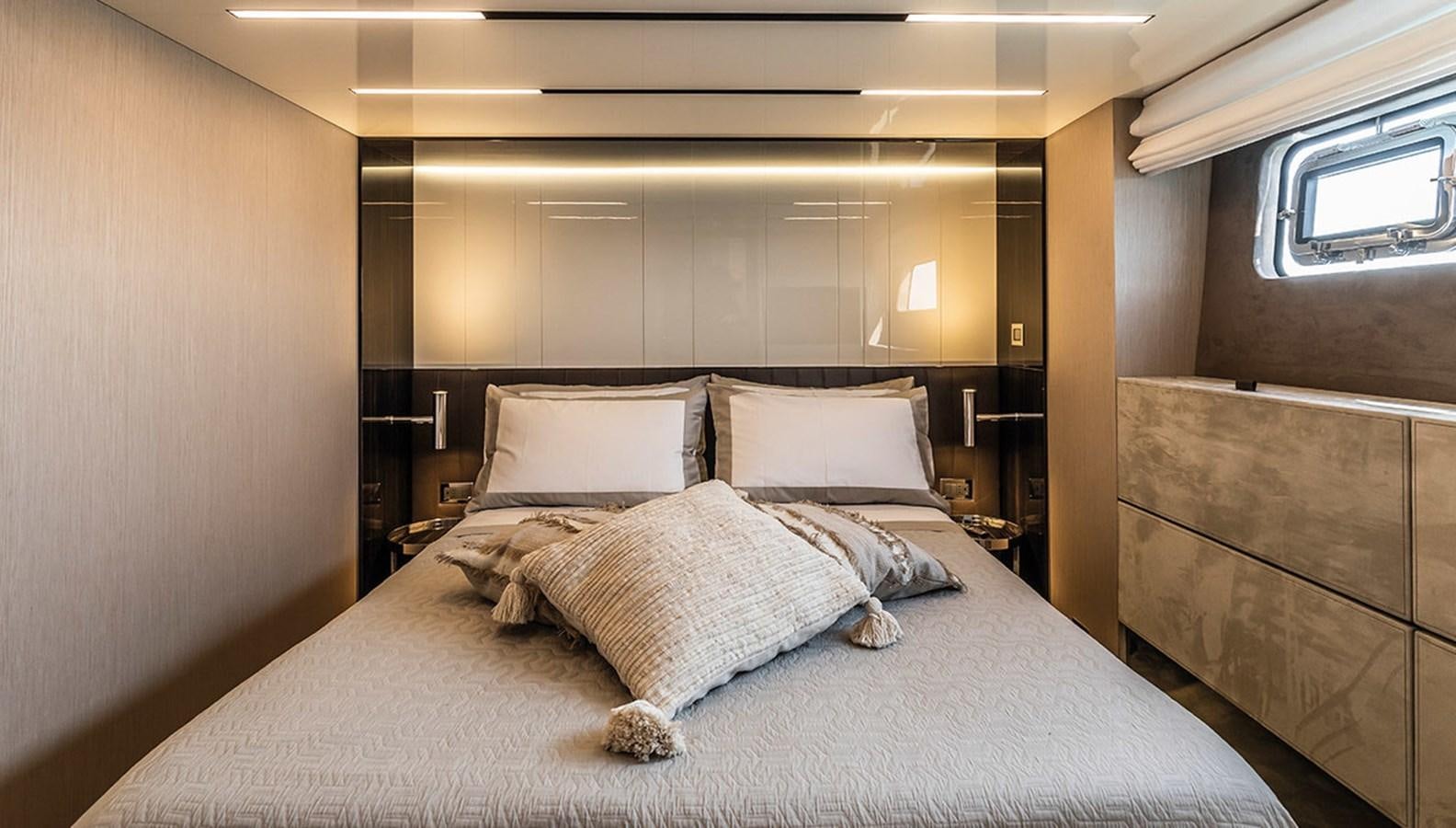 a bed with pillows aboard SESSANTASETTE 67 Yacht for Sale