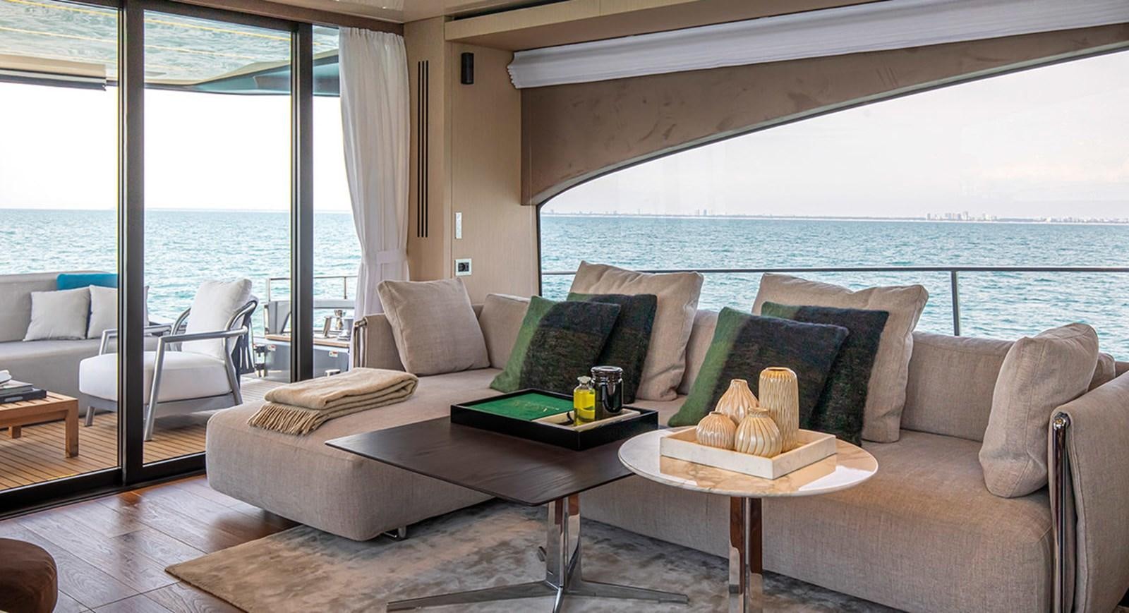 a living room with a large window aboard SESSANTASETTE 67 Yacht for Sale