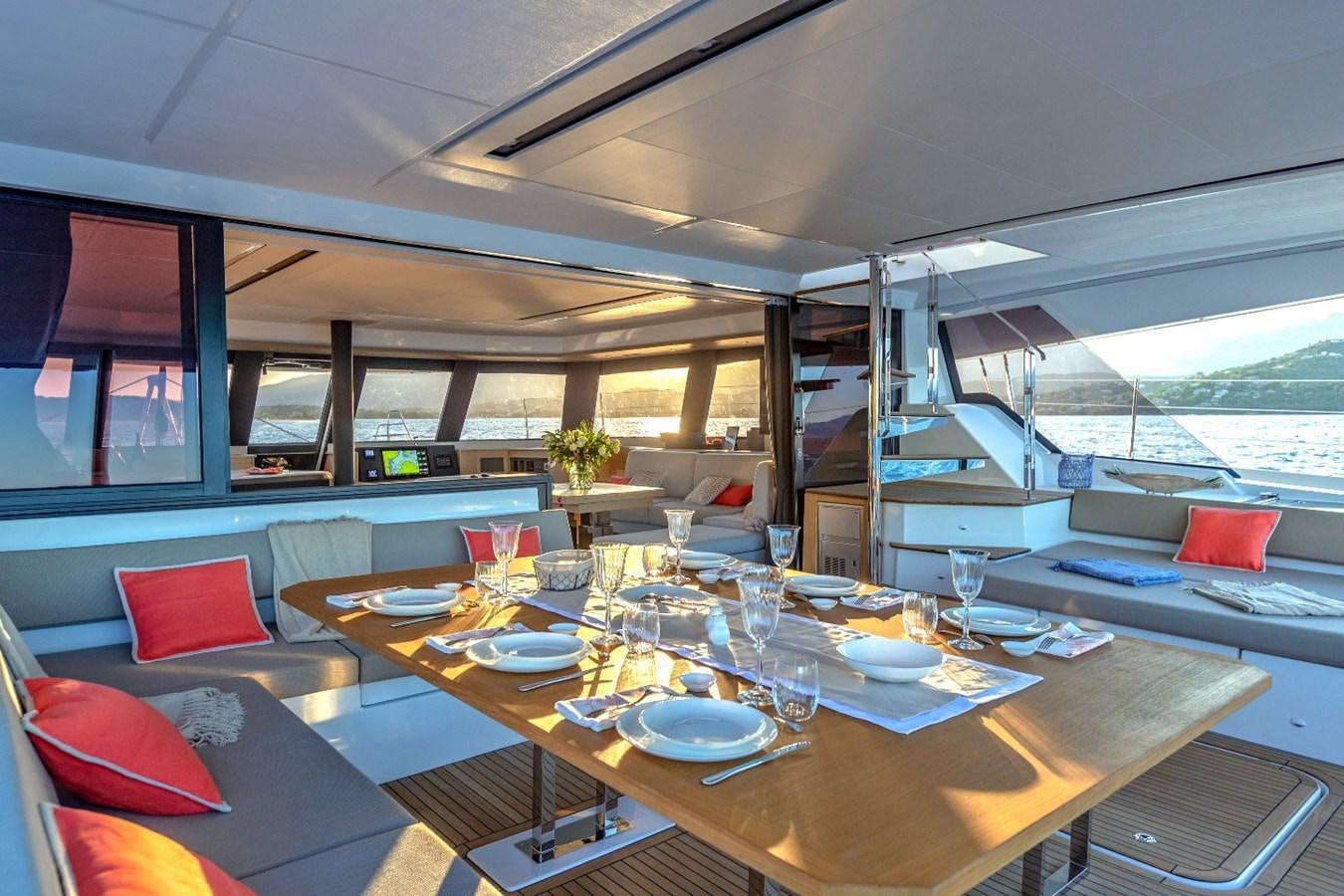 a table with plates and cups on it aboard INSPIRANTE Yacht for Sale