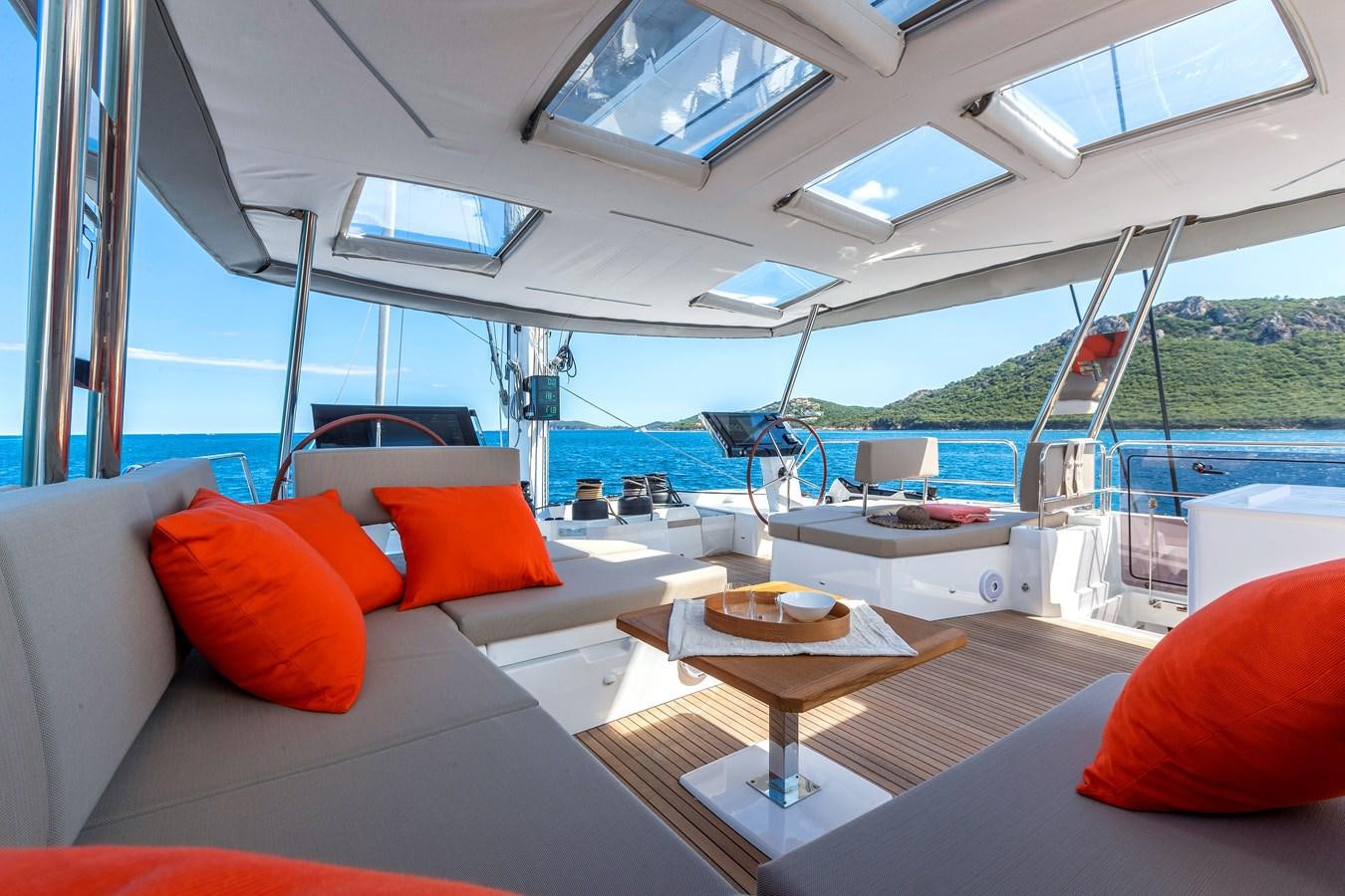 a boat with pillows and a table aboard INSPIRANTE Yacht for Sale