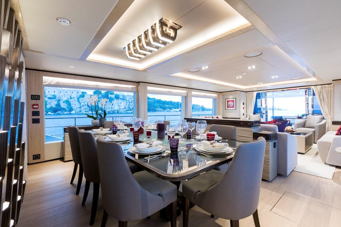 a large dining room with a large table and chairs aboard KRISHH Yacht for Sale