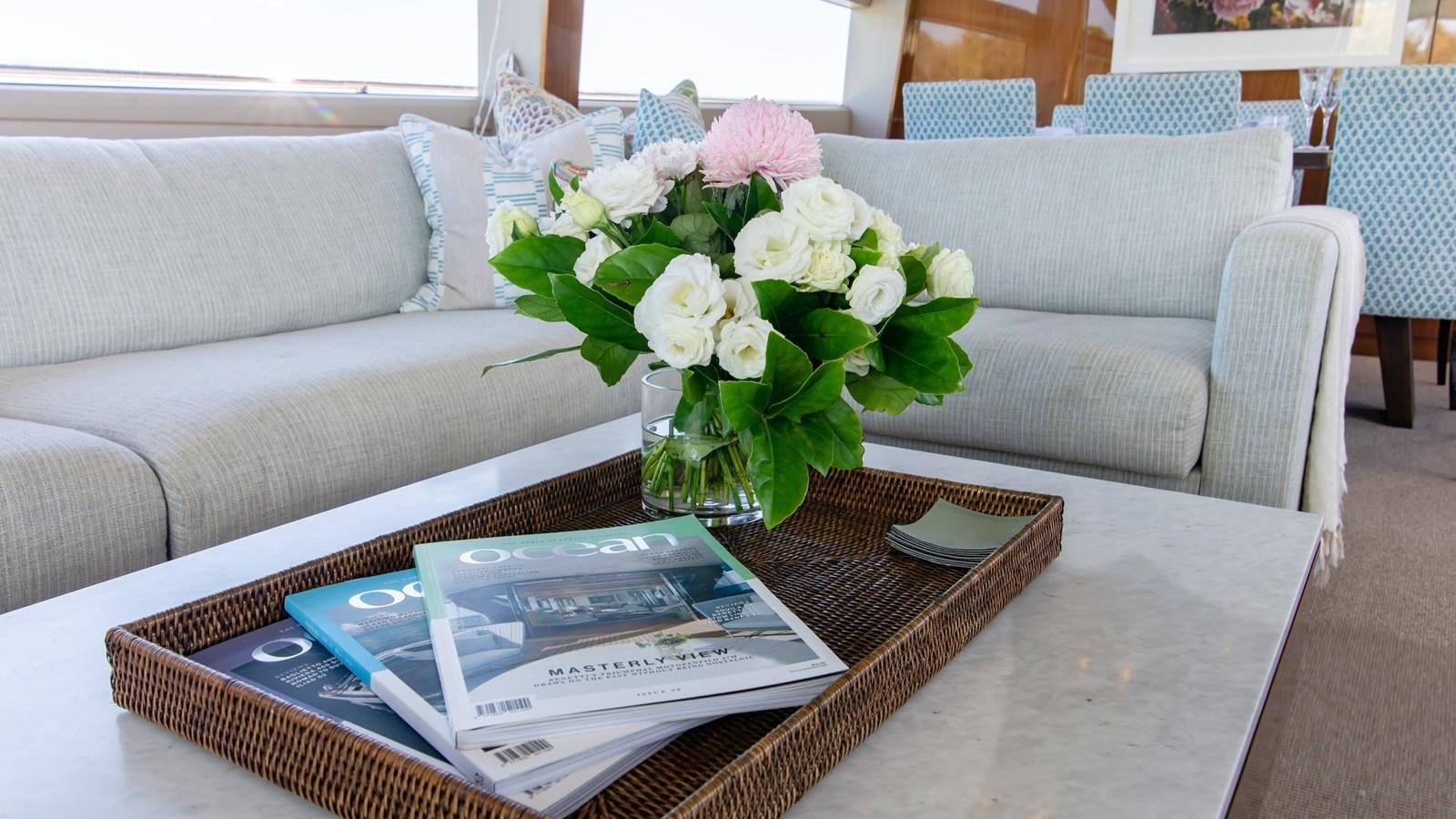 a vase of flowers on a coffee table aboard SEA WOLF Yacht for Sale