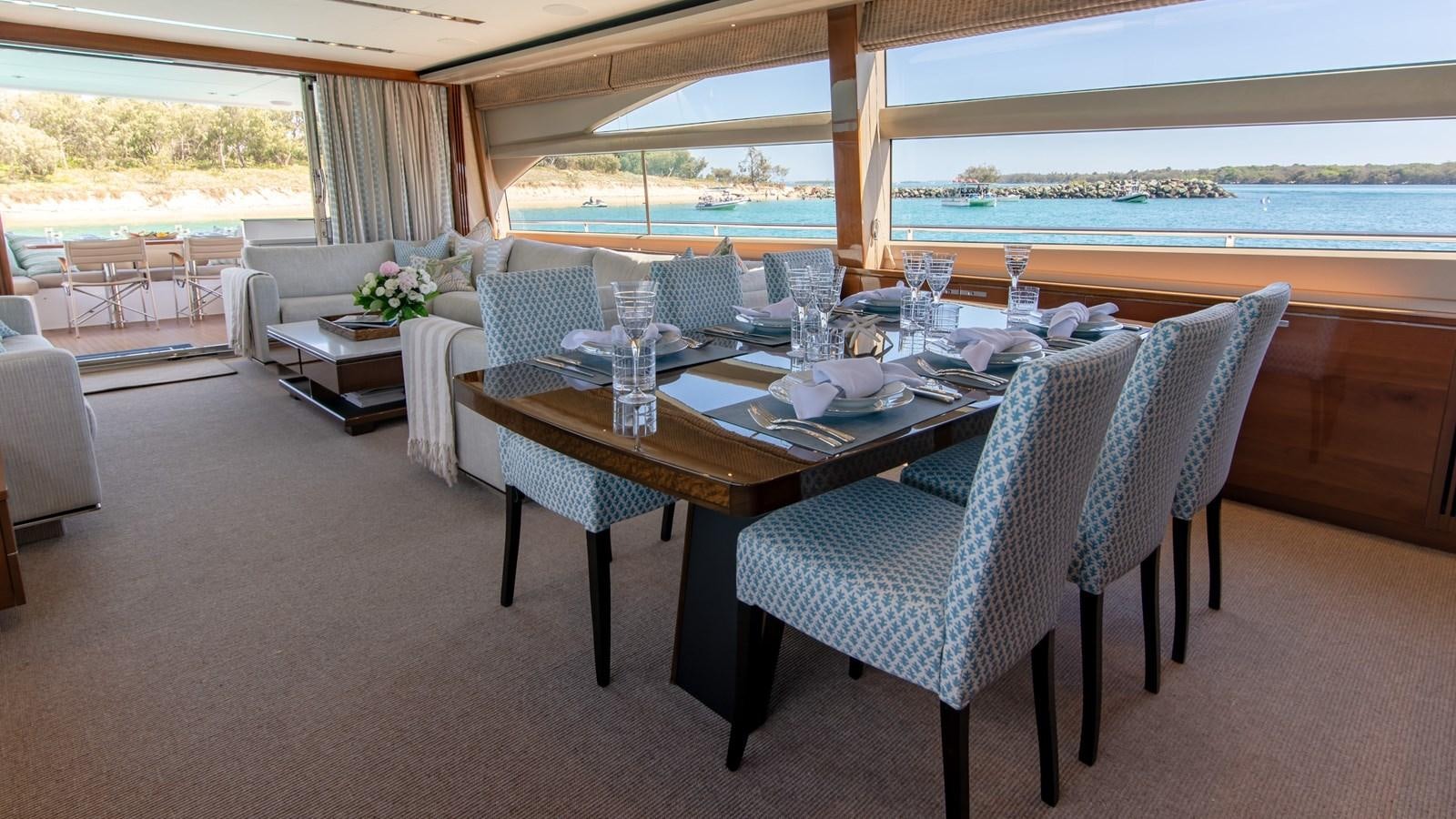 a table set with chairs and a view of the ocean aboard SEA WOLF Yacht for Sale