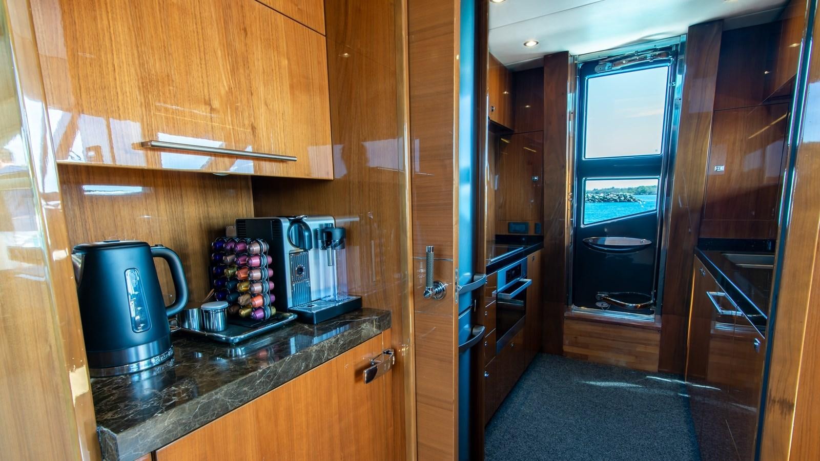 a kitchen with wooden cabinets aboard SEA WOLF Yacht for Sale